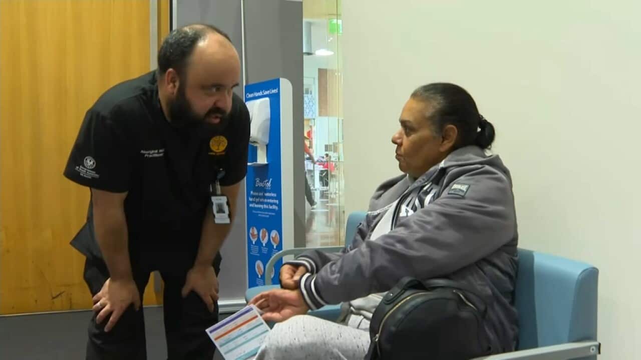 An Aboriginal Primary Health physician from Watto Purrunna talking to a client before administering a COVID-19 vaccine.