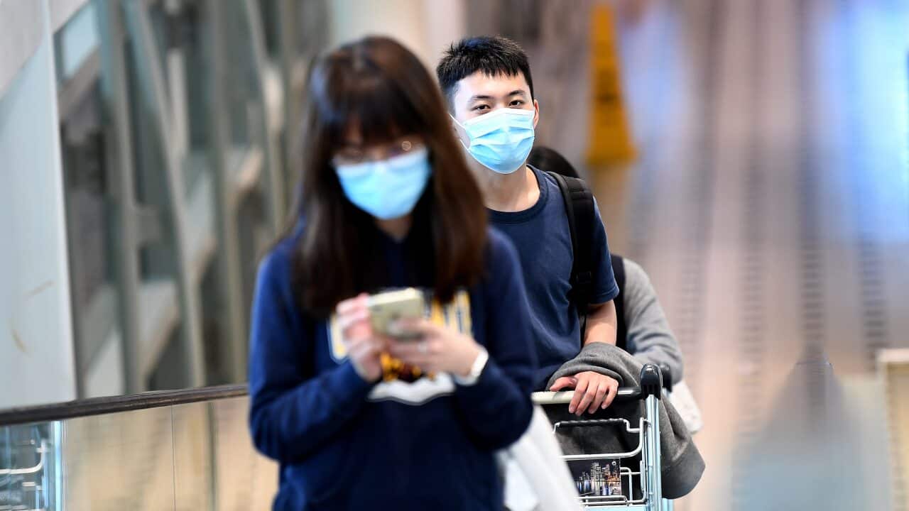 Passengers wear face masks at the International Airport in Brisbane