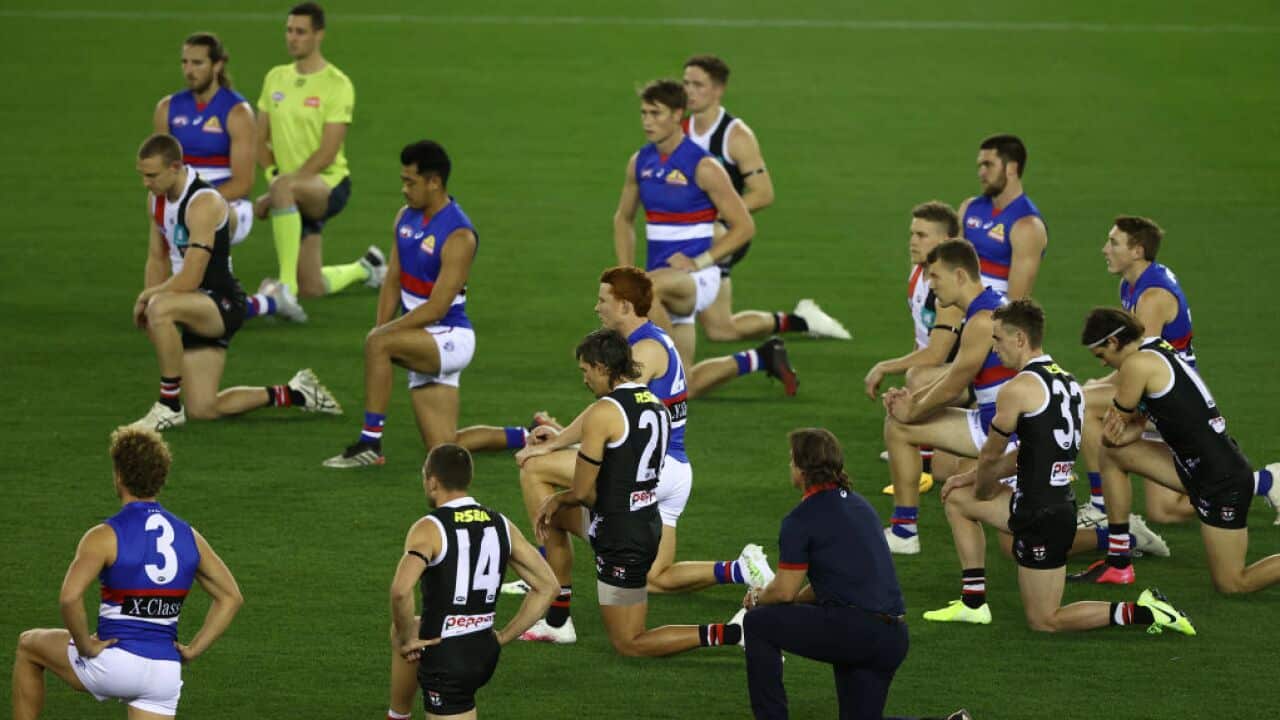 Players kneel during the round 3 AFL match between the St Kilda Saints and the Western Bulldogs on June 2020 in Melbourne.