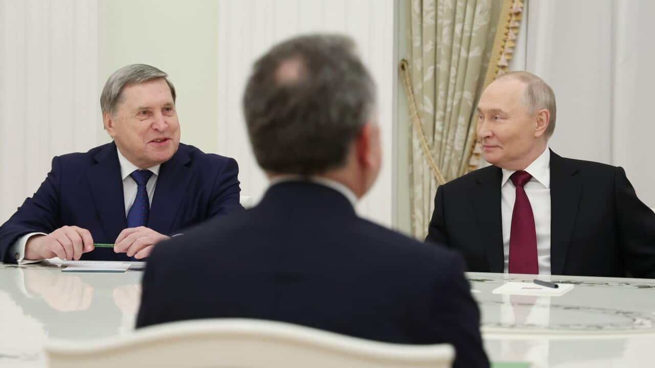 Three men sitting at a negotiation table including Vladimir Putin