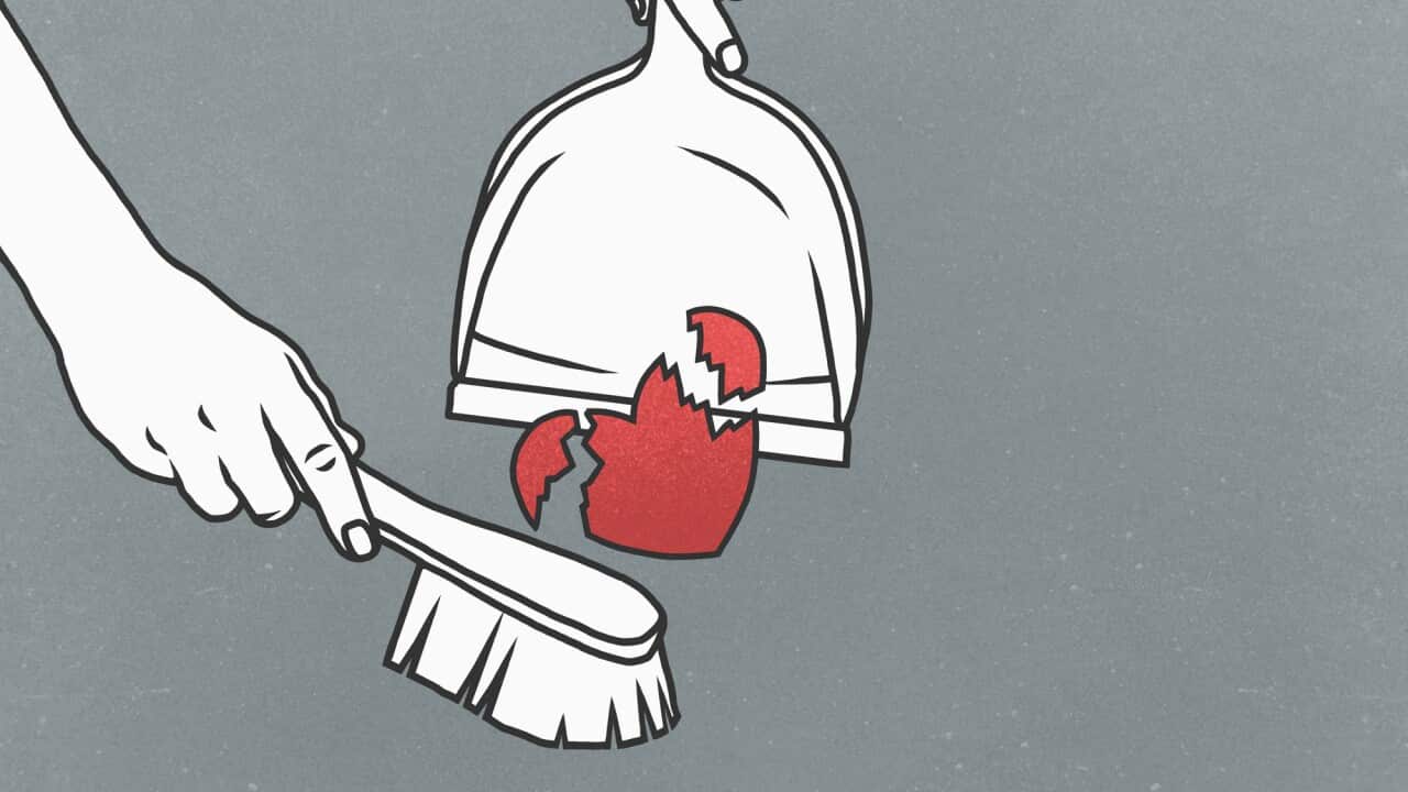 Woman sweeping broken heart into dustpan