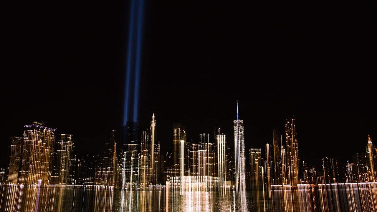 The Tribute in Light rising above the lower Manhattan skyline and One World Trade Center.