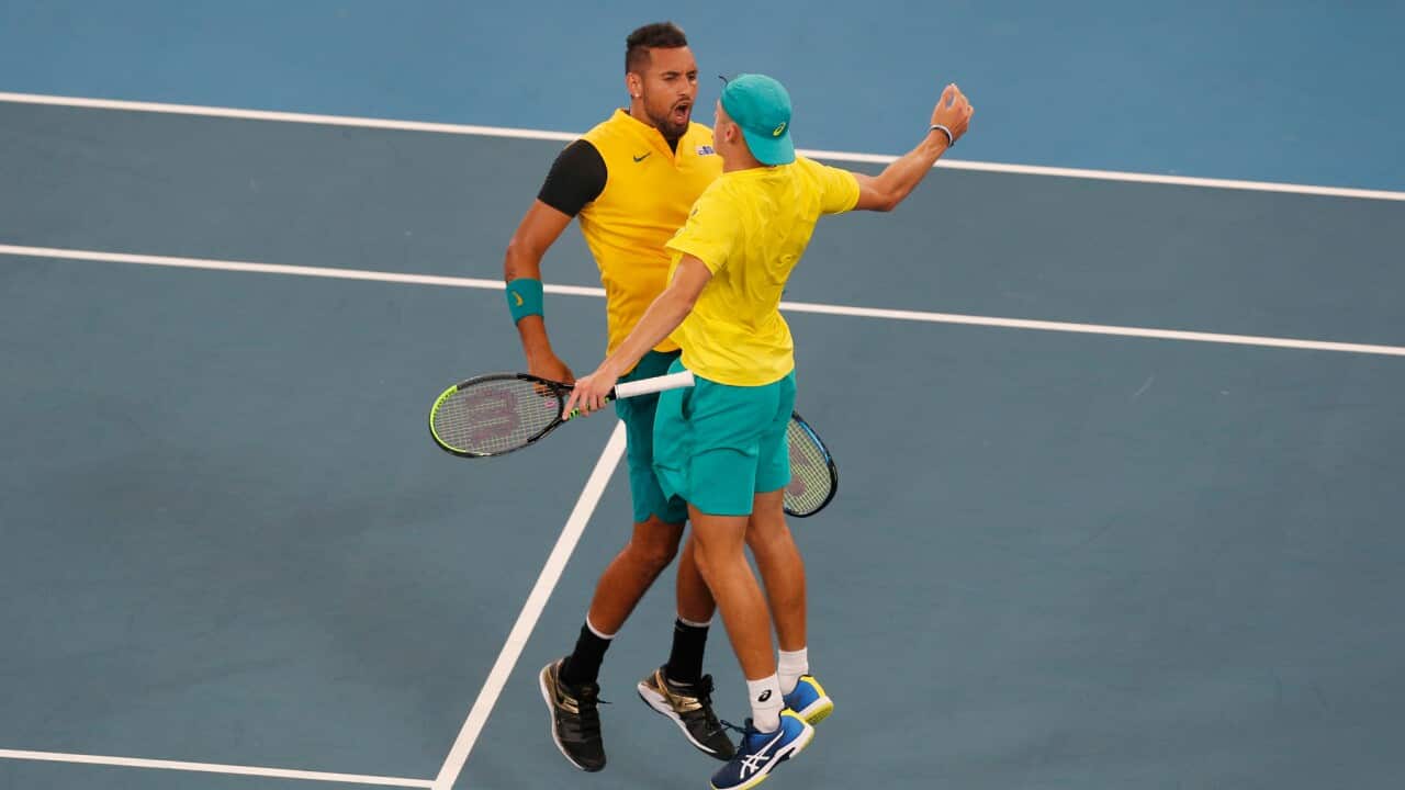 Australia's Alex De Minaur, left, and Nick Kyrgios celebrate after winning a match point against Britain's Jamie Murray and Joe Salisbury