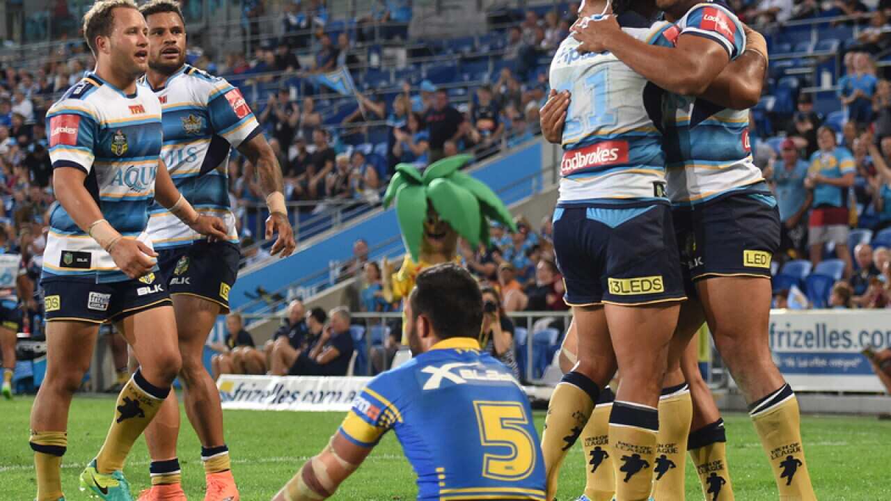 Titans' Nene McDonald (R) celebrates with players after scoring a try