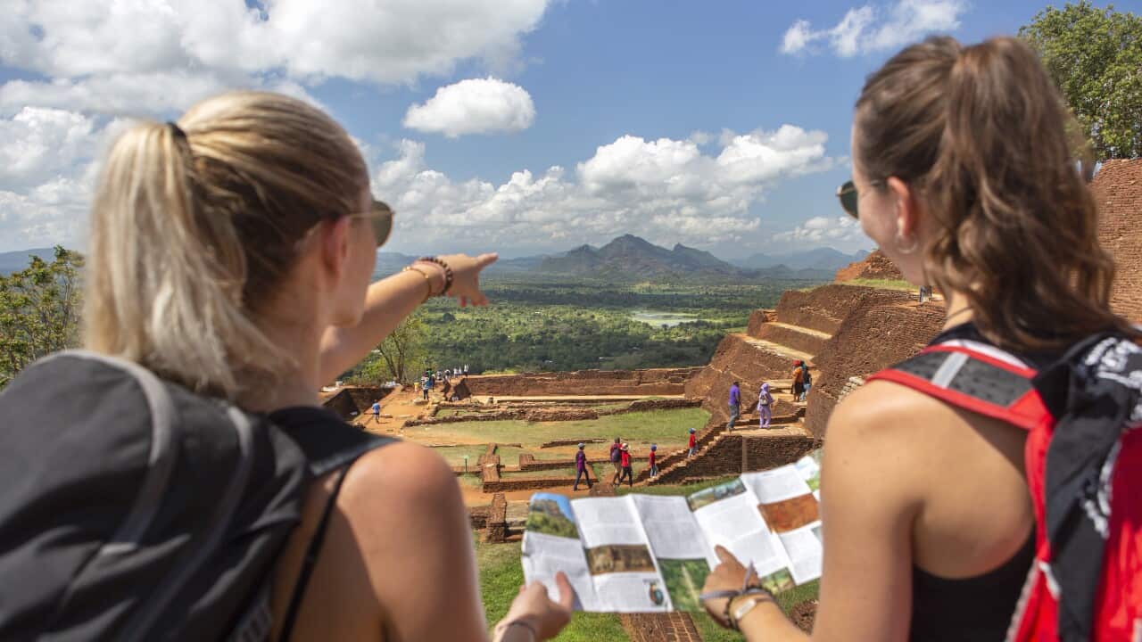 Two women hikers wearing backpacks on vacation at Sigiriya (Lion Rock) in central Sri Lanka, South Asia