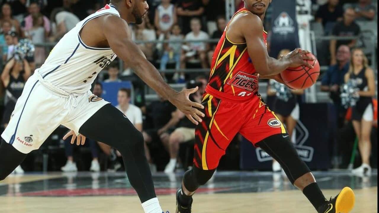 Casper Ware of Melbourne (R) contests with Perrin Buford of Brisbane