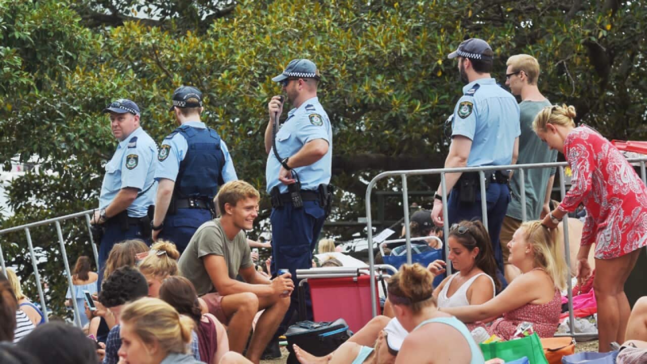 Police patrol through the crowds
