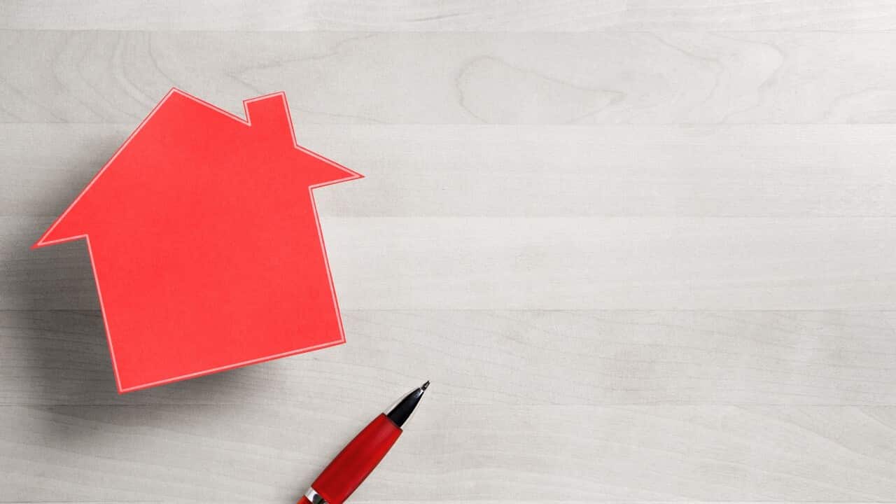 Real estate business. House for sale. Cottage made from cardboard paper on wooden table. House warming party template. Selling and buying home. Empty blank negative copy space.