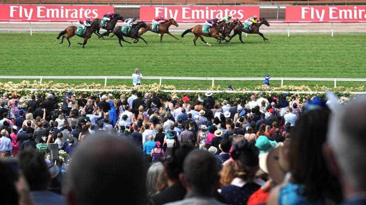 ockeys ride their horses to the finish line during race 2, the TAB.COM.AU trophy, on Melbourne Cup Day at Flemington Racecourse in Melbourne, Tuesday, Nov. 3, 2015. (AAP)