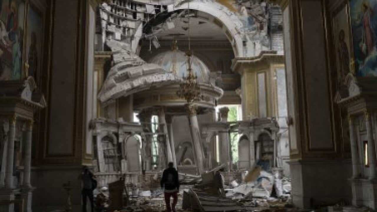 Church personnel inspect damages inside the Odesa Transfiguration Cathedral