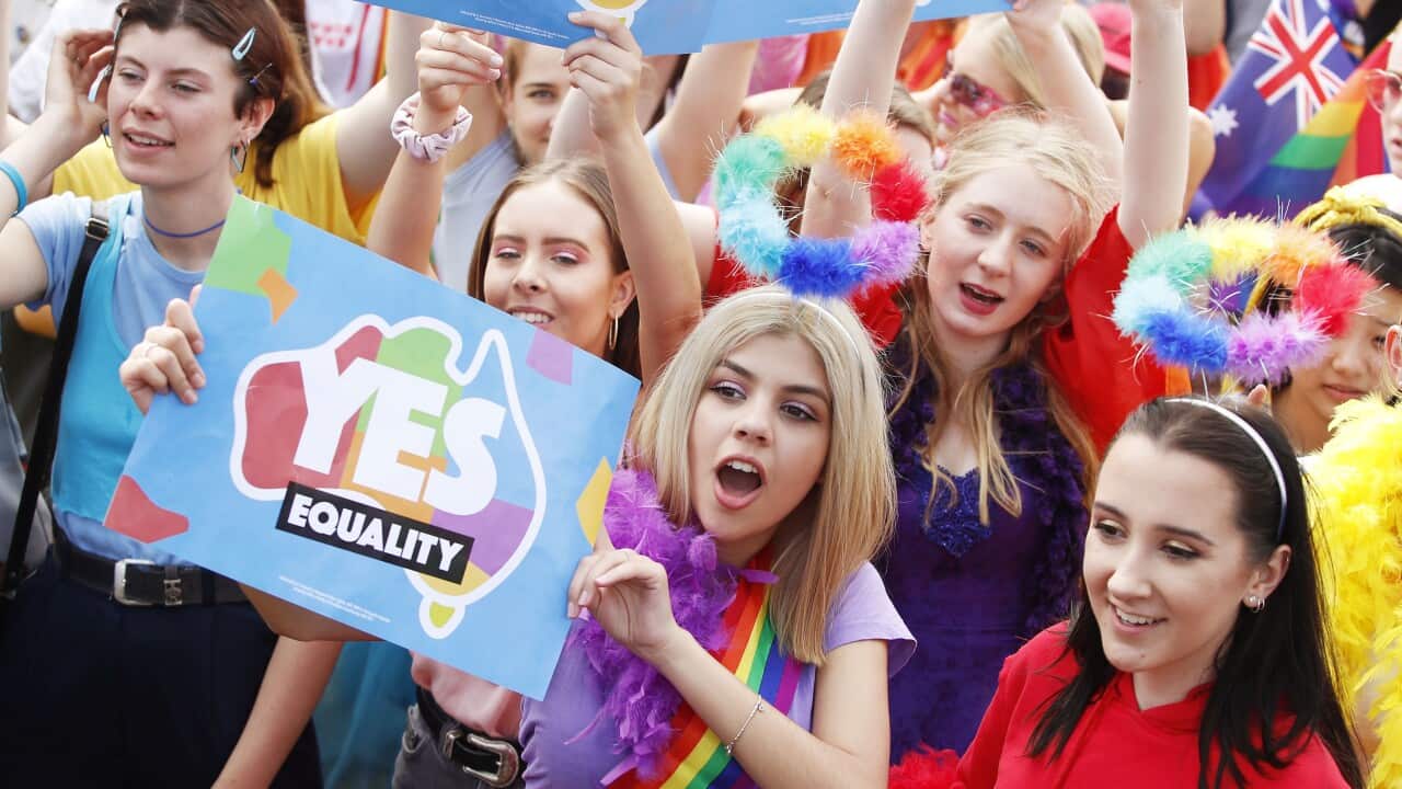 A supporter of marriage equality holds up a ‘yes’ sign at Victoria Park in Sydney.