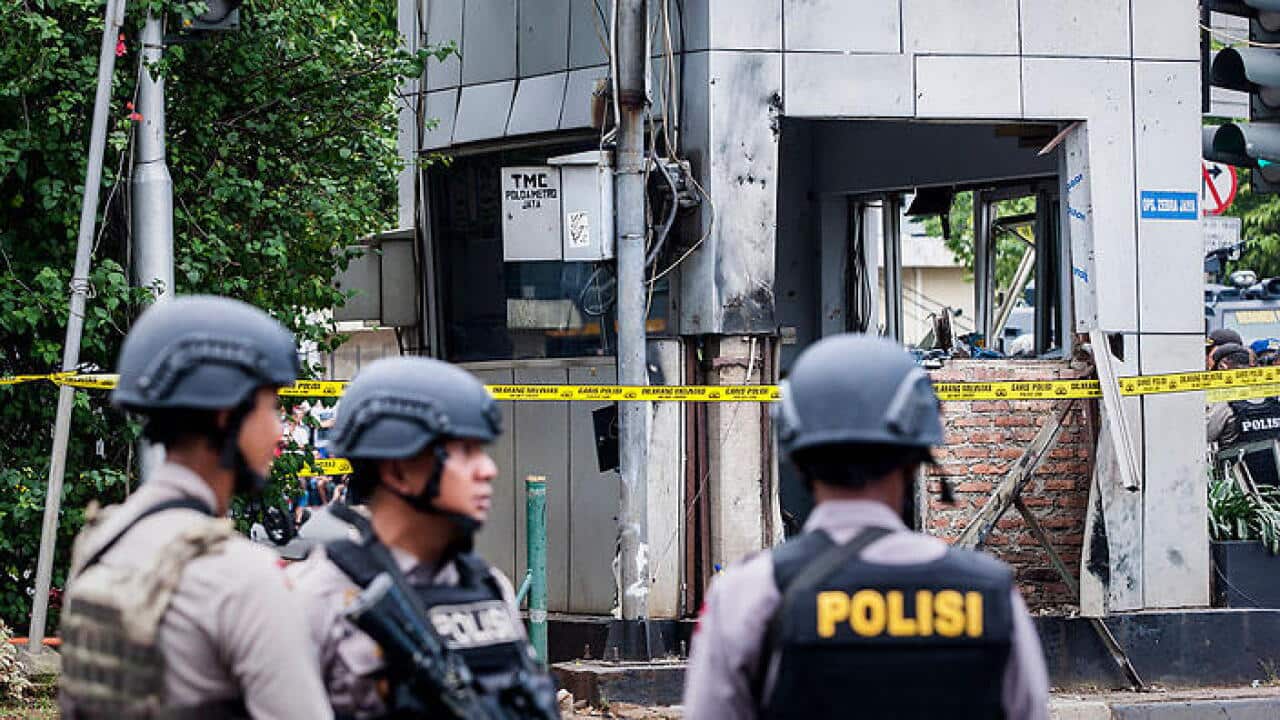 Indonesian policemen stands guard near the blast site after a series of explosions hit the Indonesia capital Jakarta. (Getty images)
