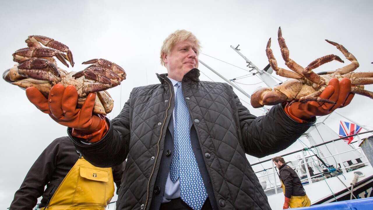UK Prime Minister Boris Johnson holding crabs in Stromness