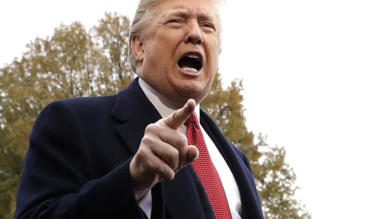 President Donald Trump speaks to the media before leaving for France