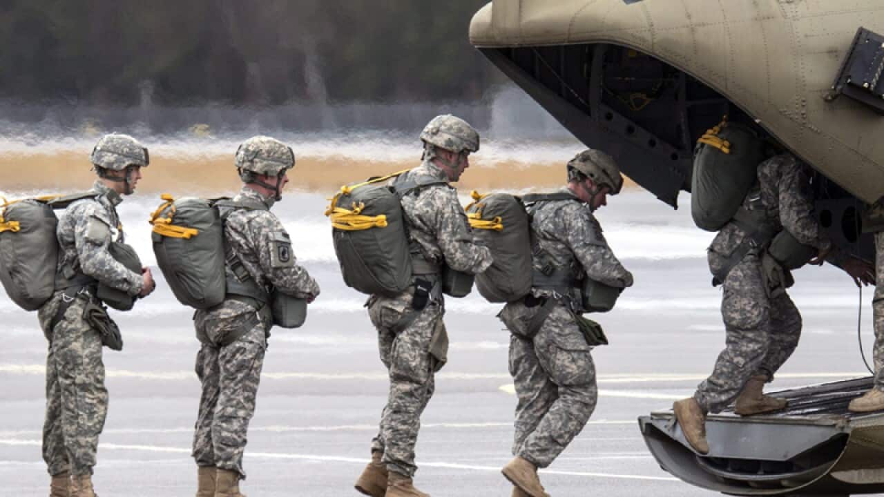 US Army paratroopers enter a helicopter