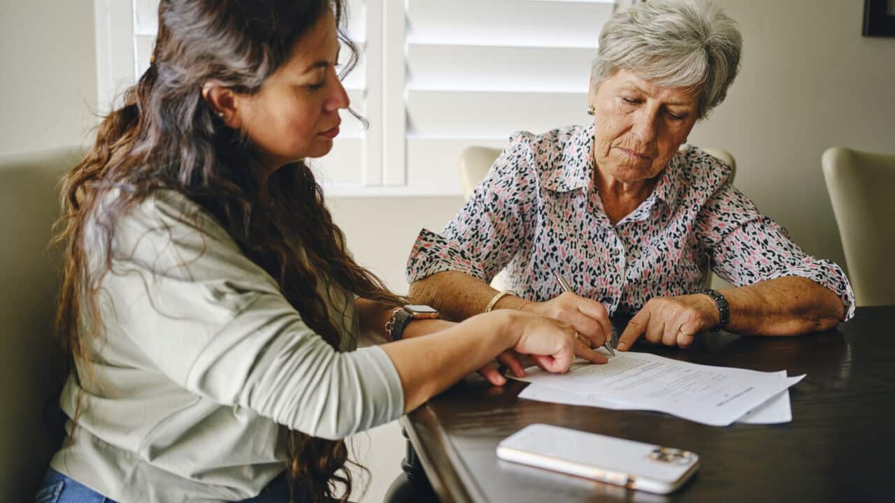 Woman Helping a Senior Wtih Documents