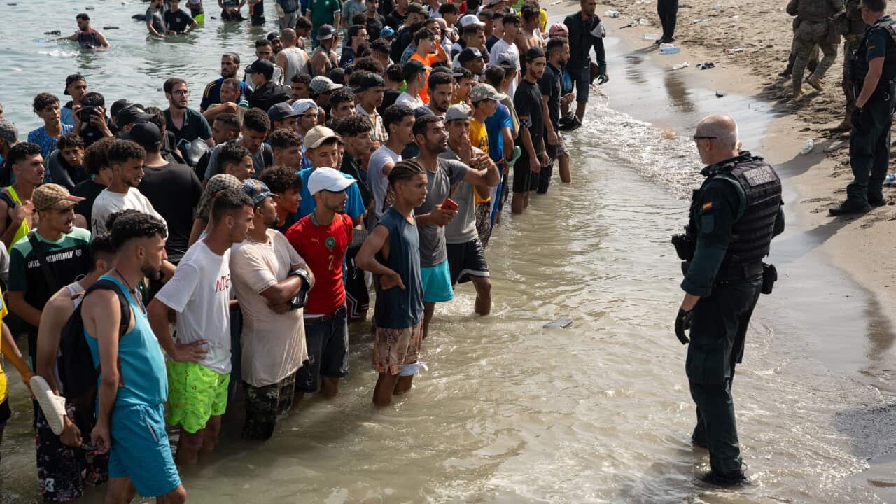 Migrants gather near the border crossing between Morocco and the Spanish enclave of Ceuta on July 31, 2026.