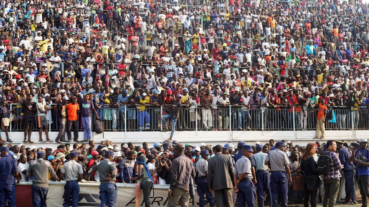 Crowds attend a funeral parade of the former Zimbabwean President Robert Mugabe at Rufaro Stadium in Harare