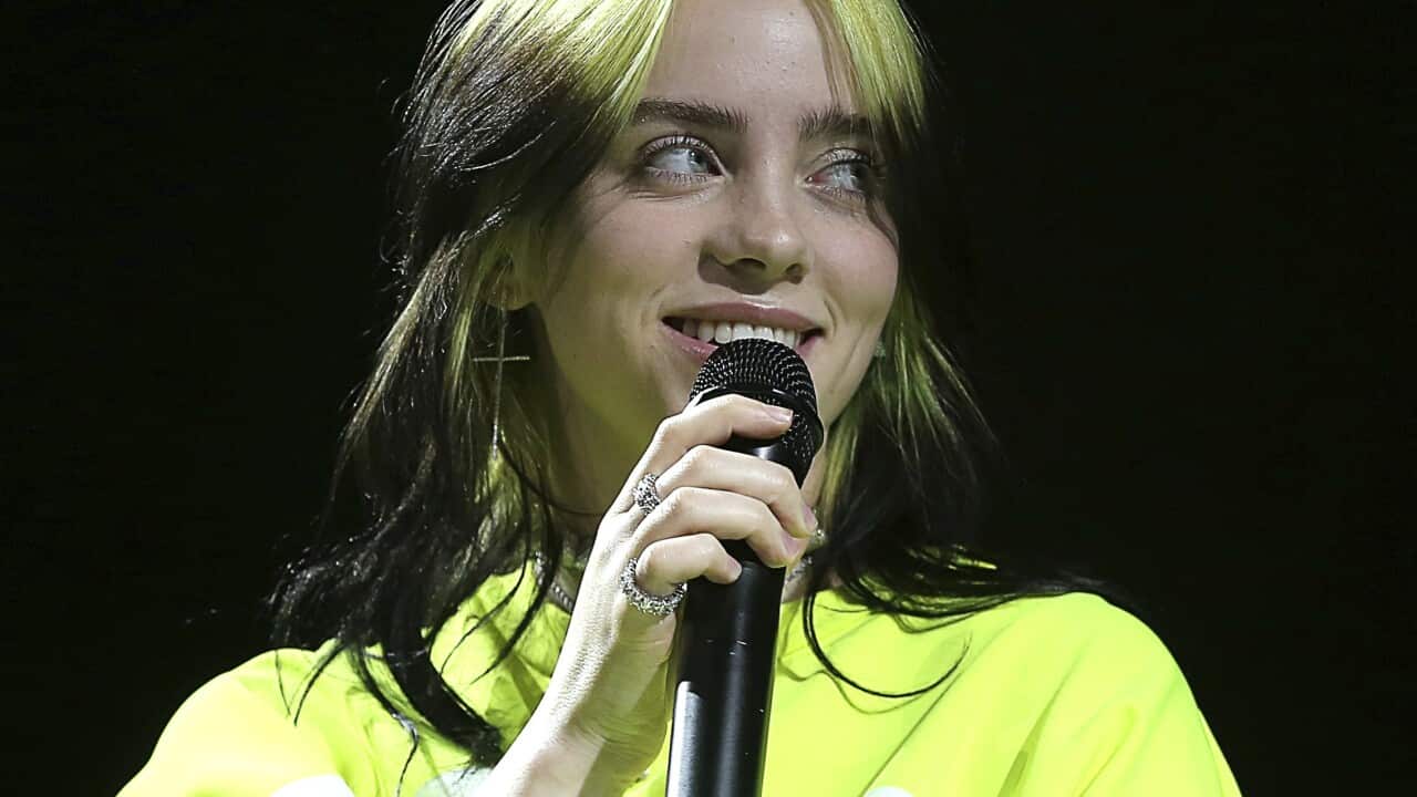 Billie Eilish holding a microphone
