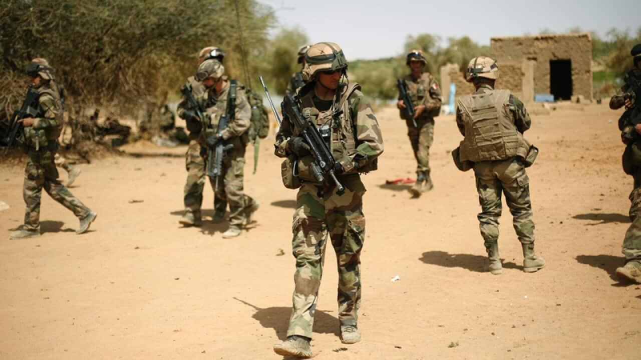 French soldiers secure the area at the entrance of Gao, northern Mali