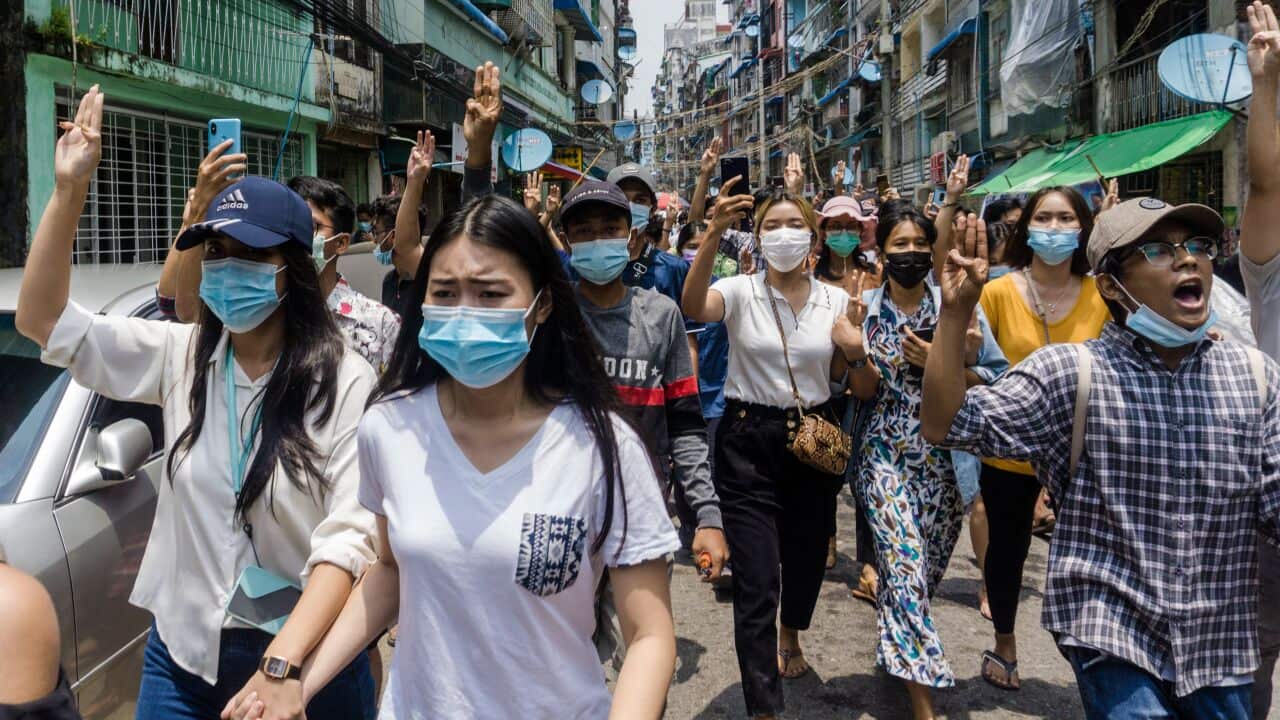 Protesters make the three-finger salute during a demonstration against the military coup in Yangon's Sanchaung township.