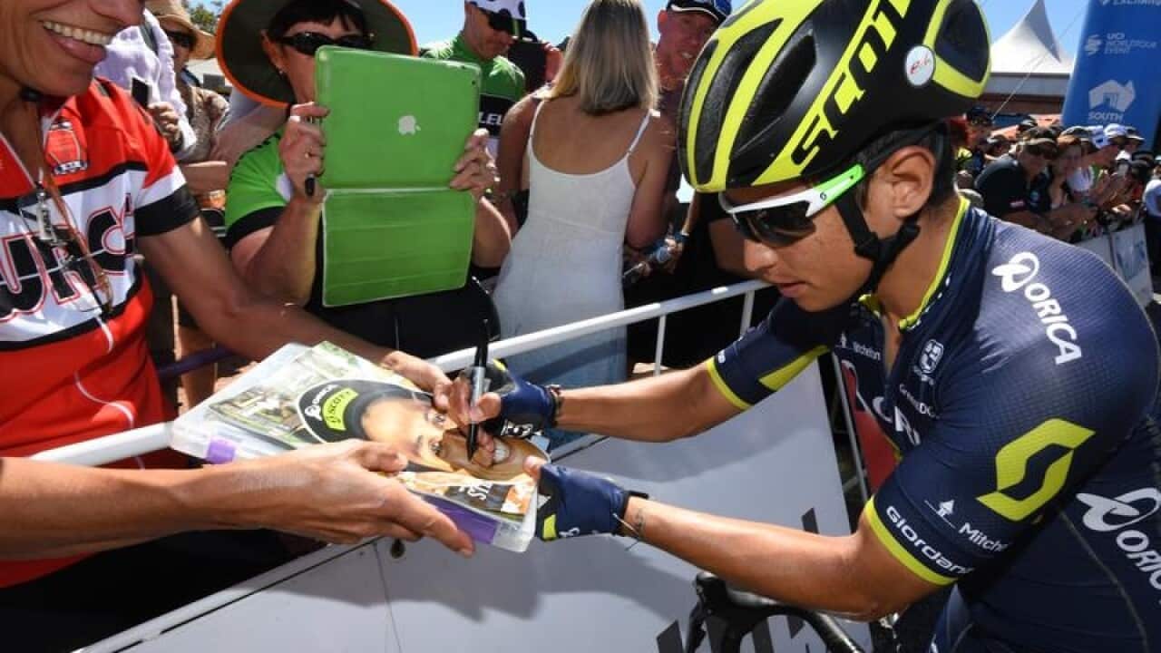 Esteban Chaves of team Orica-Scott signs autographs.