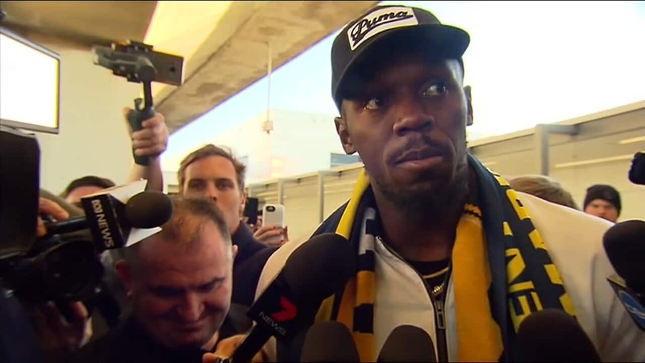 Olympic Games champion Usain Bolt addresses the media after landing in Sydney.