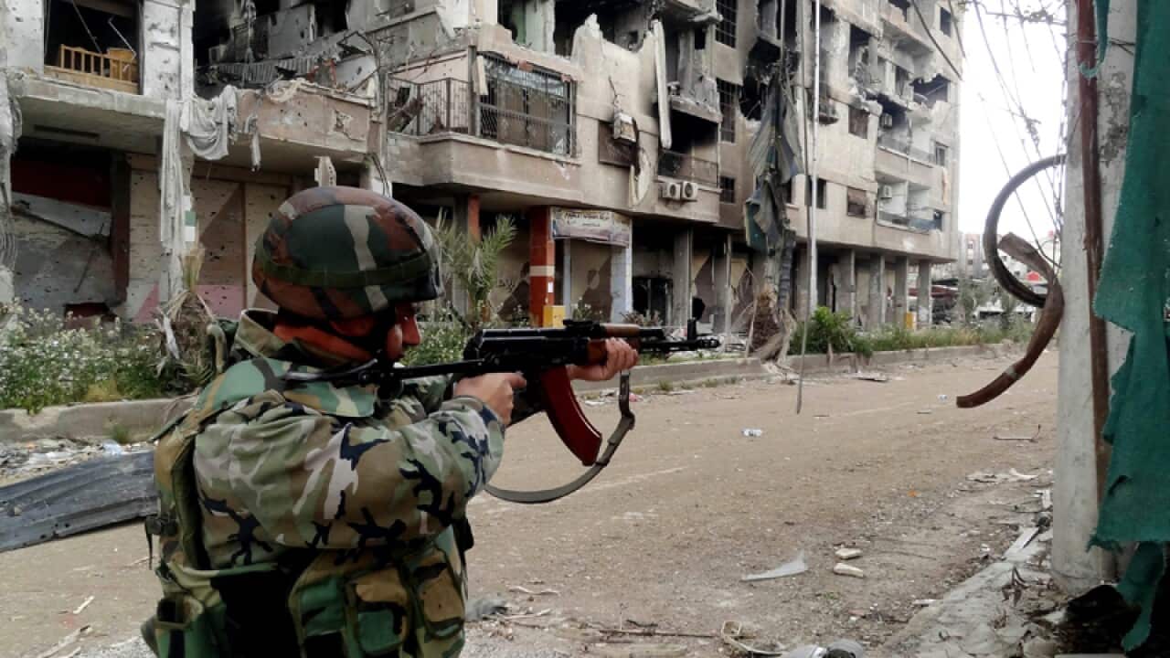 A Syrian army soldier taking position in Damascus
