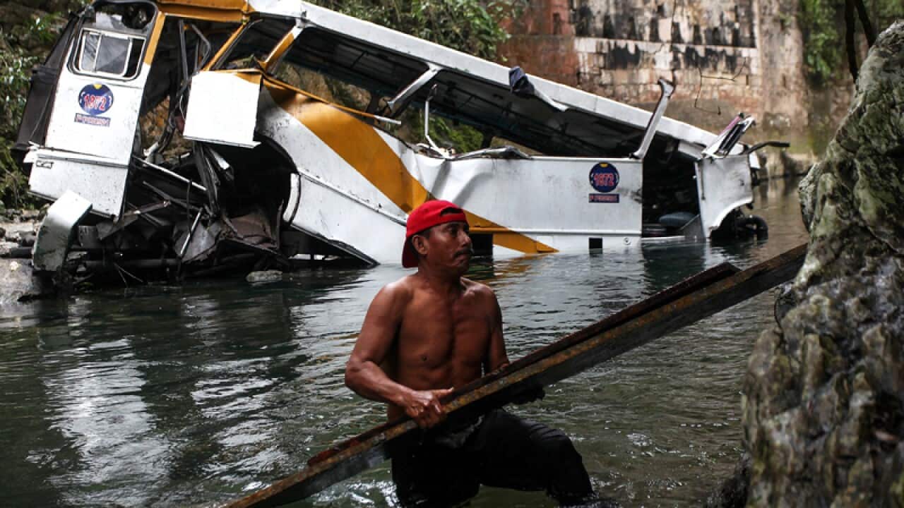 A passenger bus lays in a ravine in Atoyac