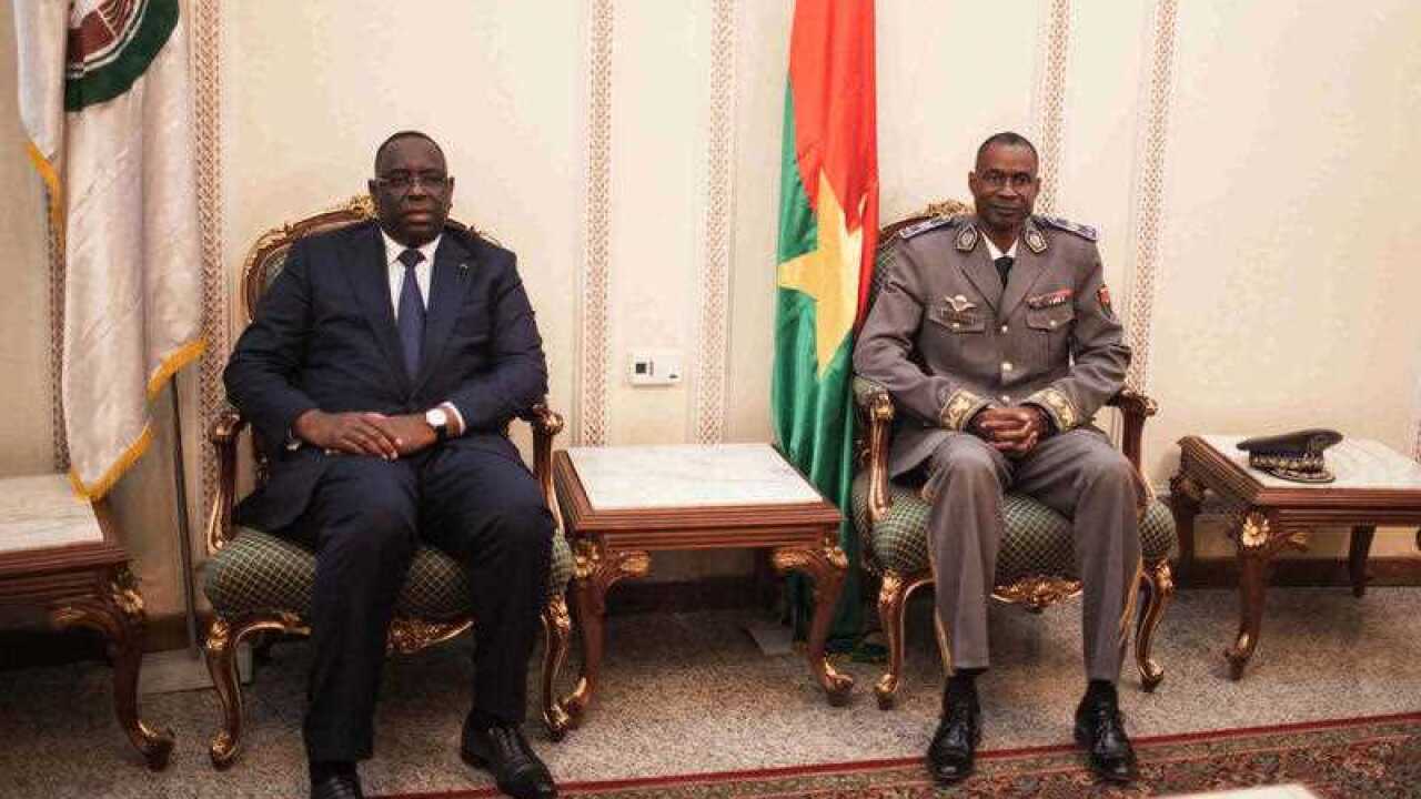 Burkina Faso Gen. Gilbert Diendere, right, sits next to Senegal President Macky Sall