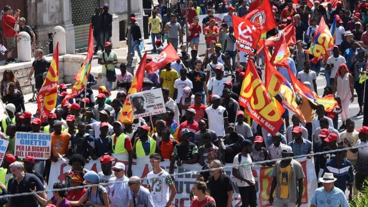 African migrant workers stage a march to protest against their work conditions, following the death of 16 of their colleagues in two separate road accidents