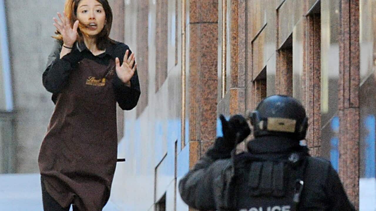 Sydney Siege hostage Elly Chen runs from the Lindt Chocolat cafe
