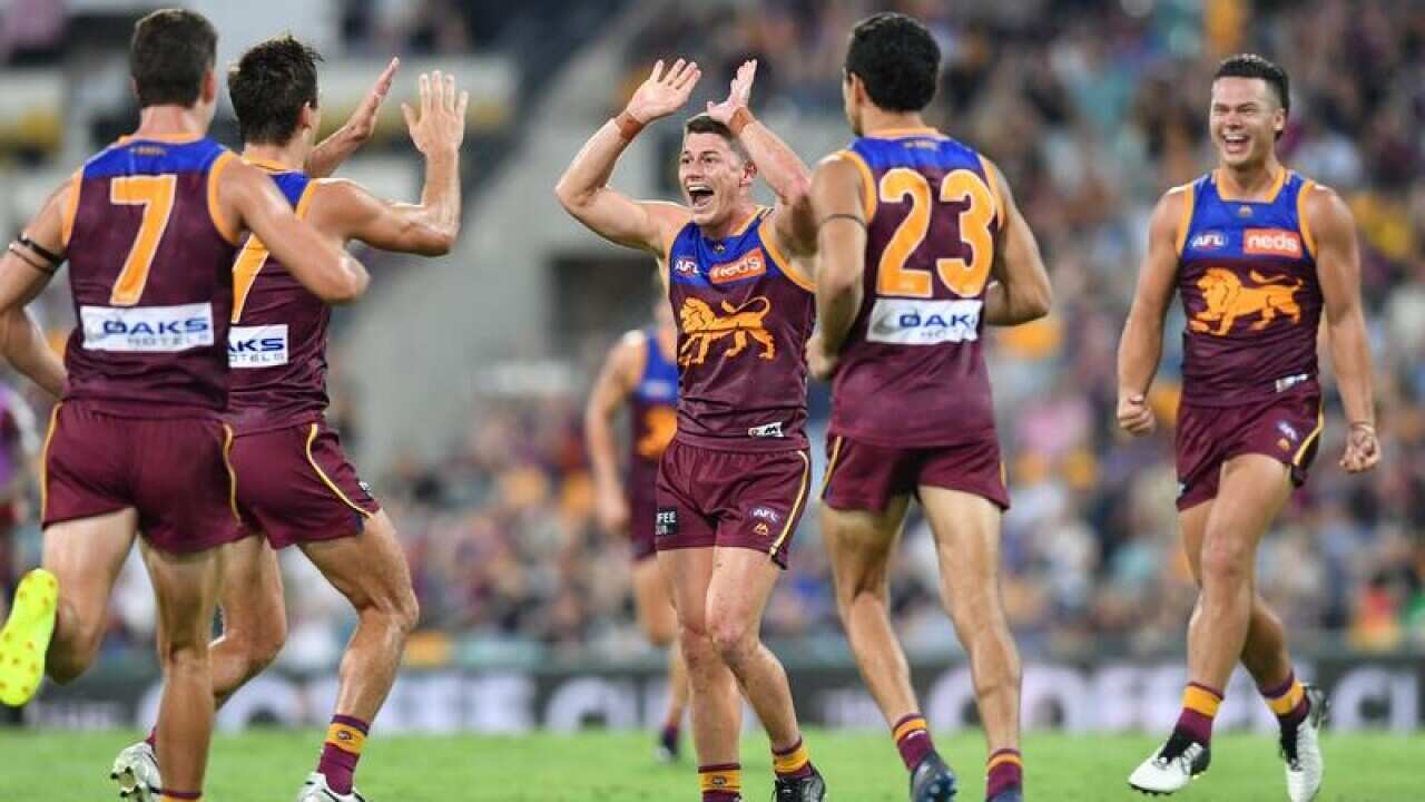 Dayne Zorko (centre) of the Lions.