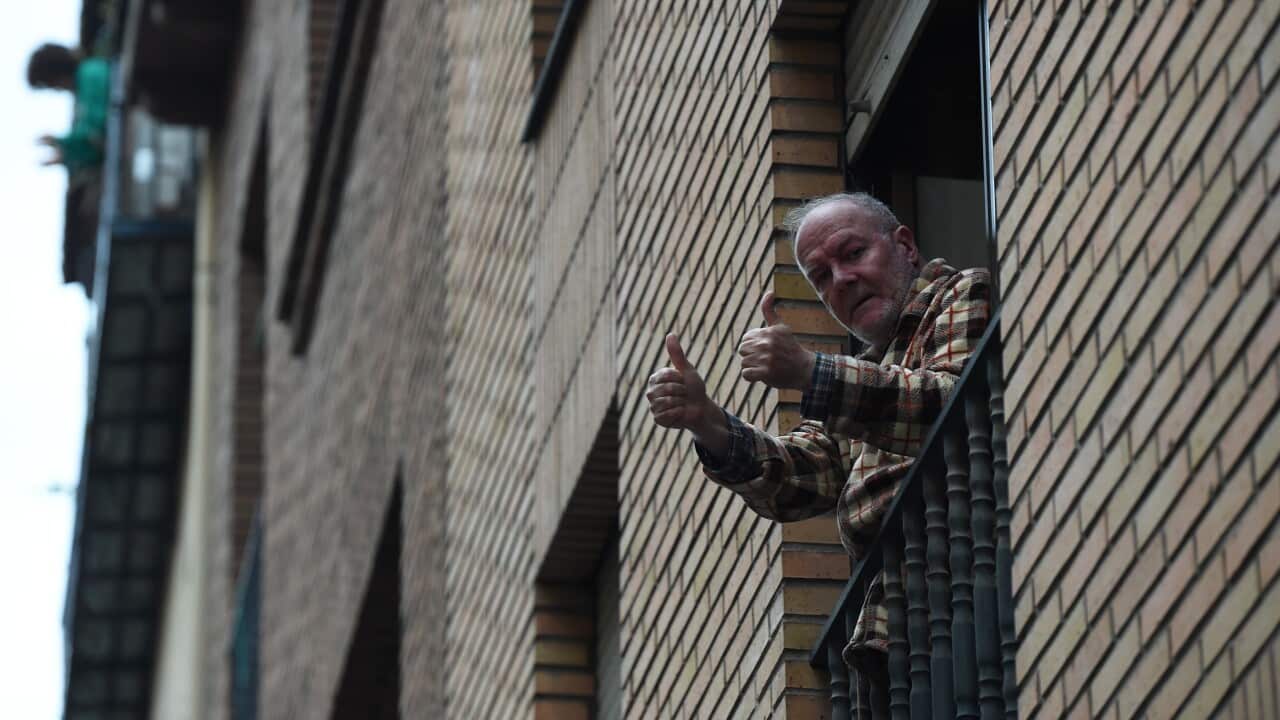 An elderly man in Madrid, Spain applauds health workers