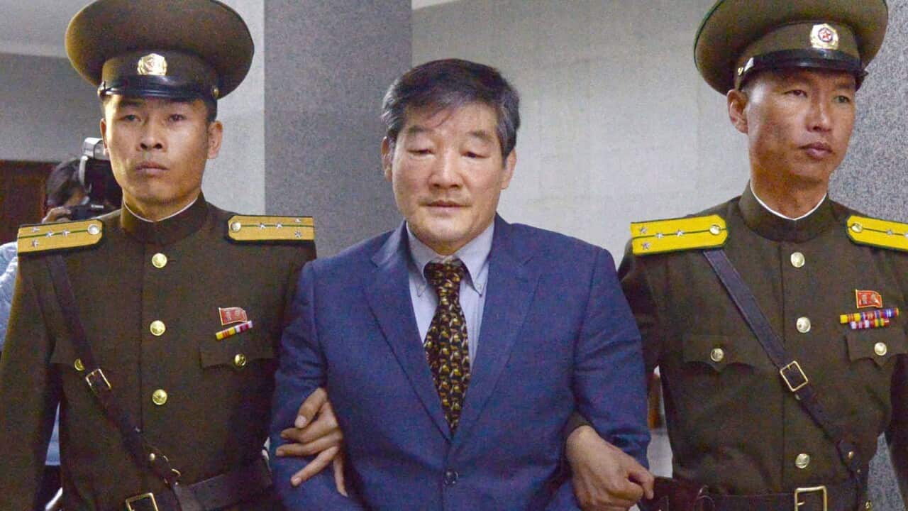 Kim Dong Chul (centre), a Korean-American man, heads to a courtroom ahead of a ruling by North Korea's top court in Pyongyang.