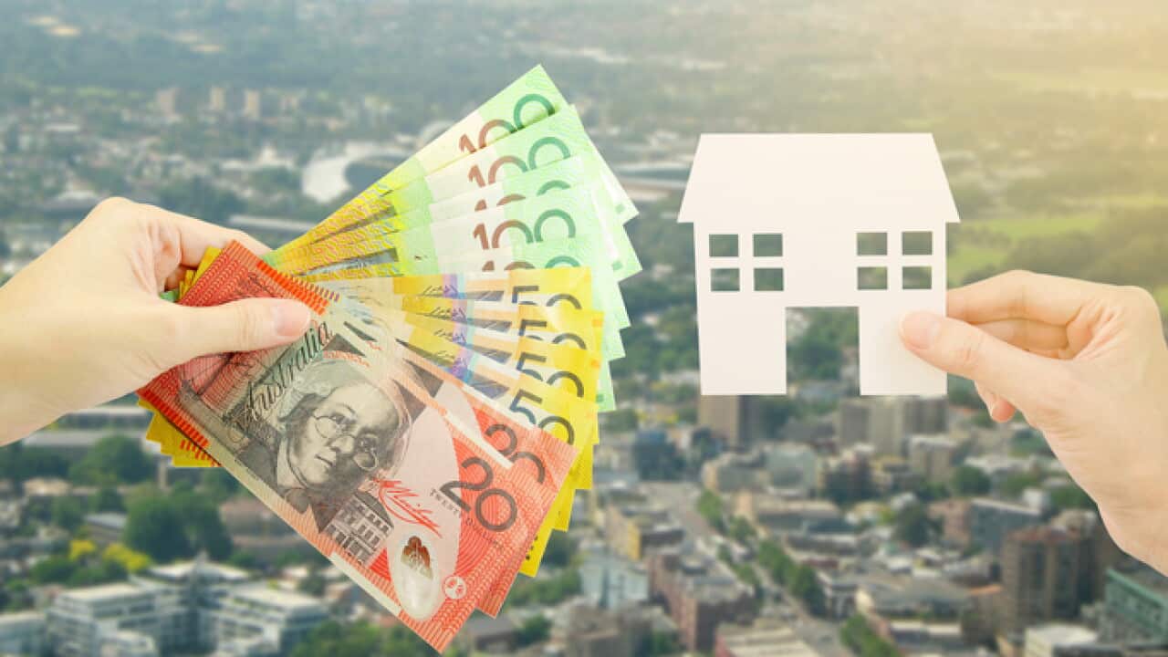 Client giving Australian money to property agent for buying house