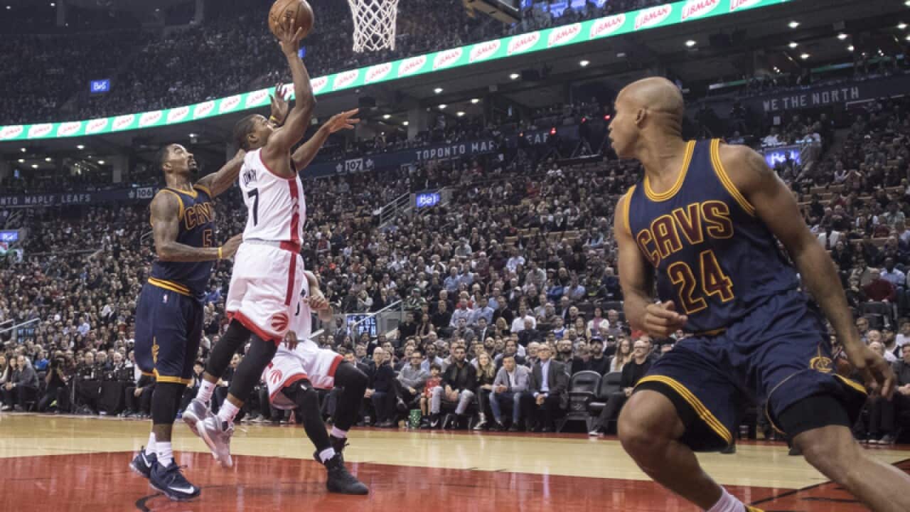 Toronto Raptors Kyle Lowry shoots on Cleveland Cavaliers J.R. Smith
