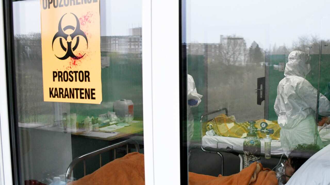 A doctor checks a COVID-19 patient in the Intensive Care Unit of the General Hospital in Sisak, Croatia