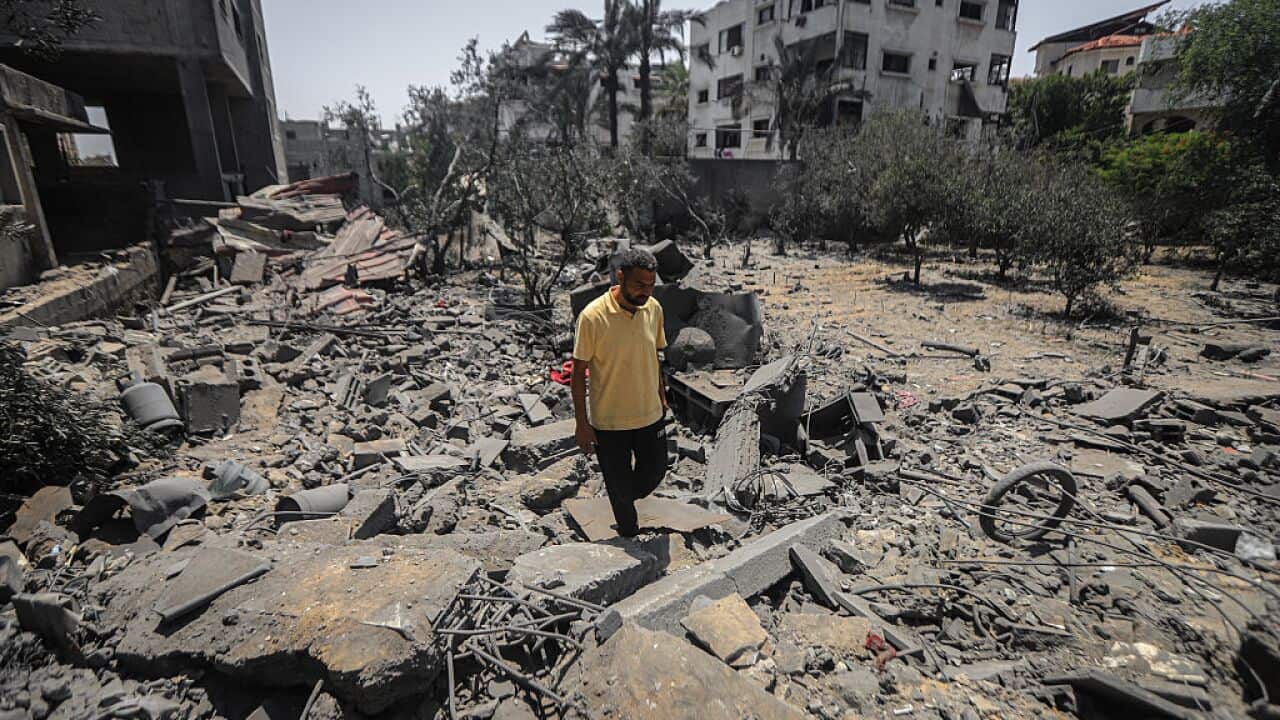 People inspect the damage after an airstrike.