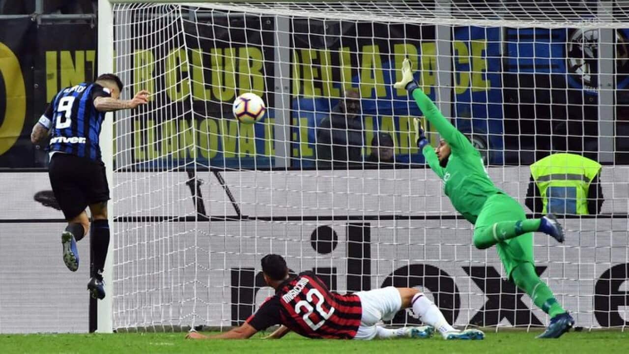 Inter Milan's forward Mauro Emanuel Icardi (L) scores the 1-0 lead during the Serie A soccer match between Inter Milan and AC Milan.