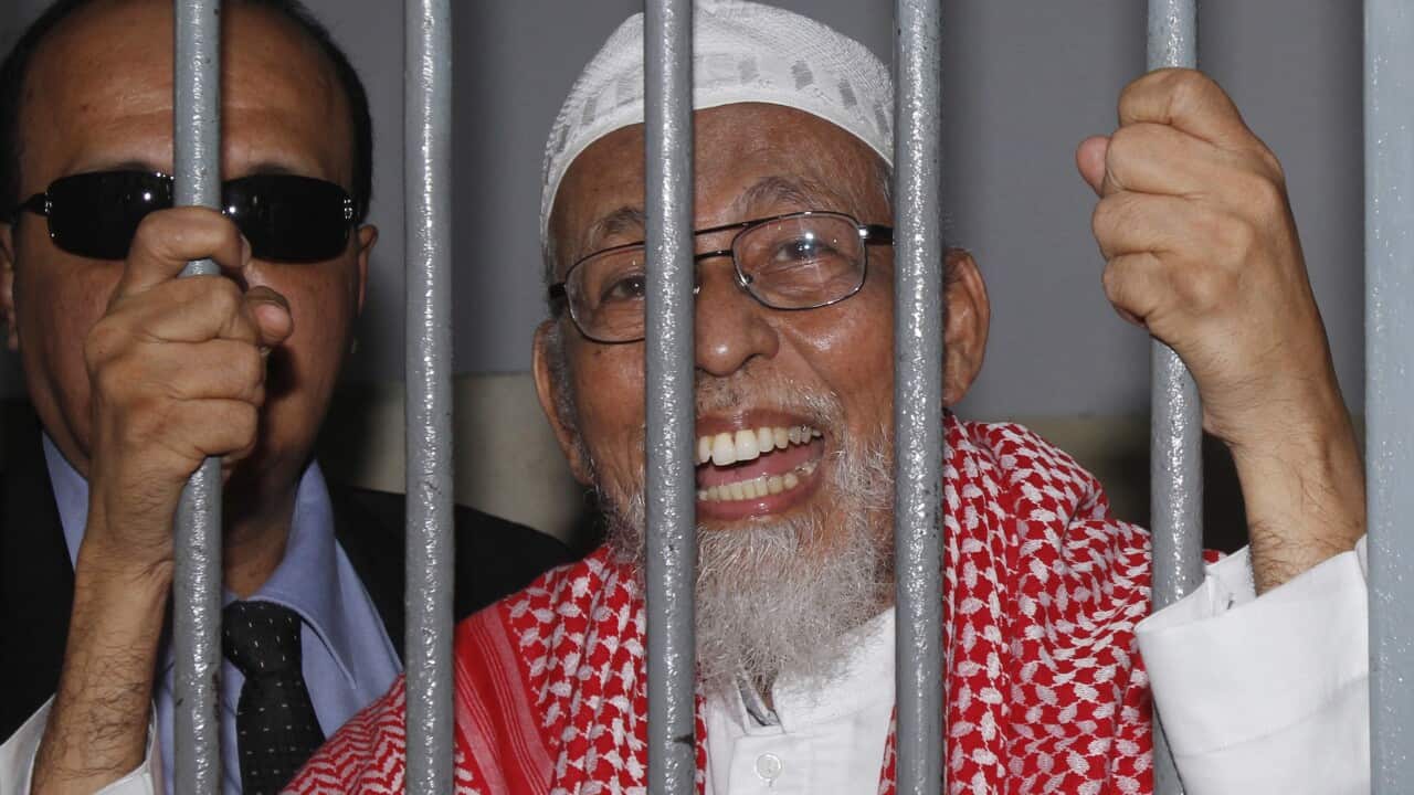 Radical Muslim cleric Abu Bakar Bashir behind bars of a holding cell before trial at a district court in Jakarta, Indonesia, Thursday, Feb. 24, 2011.