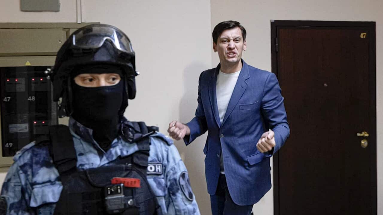 In this still from video, Russian opposition activist Dmitry Gudkov gestures as police search at his country home outside Moscow, Russia.