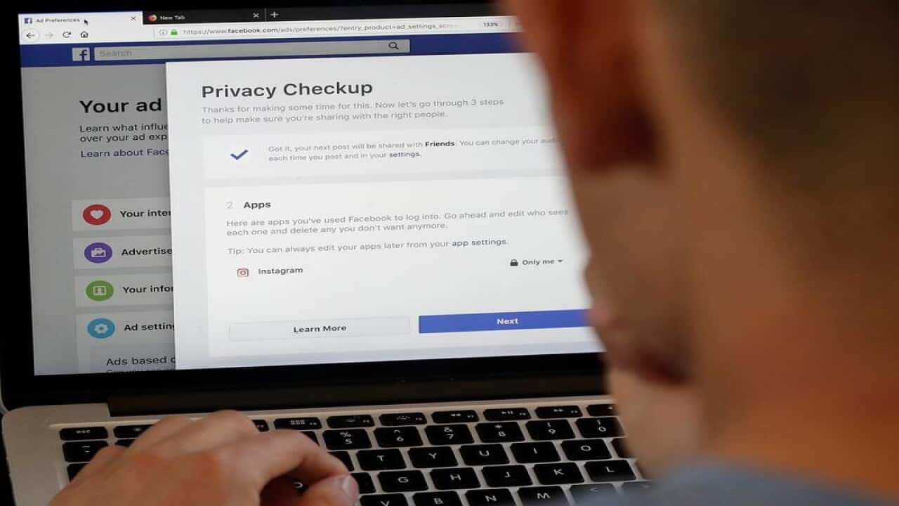 A file photo of a man looking at Facebook ad preferences pages
