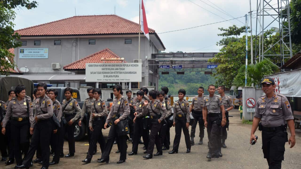 Police guards leave Indonesia's prison on Nusakambangan Island where Australians Myuran Sukumaran and Andrew Chan face execution by firing squad (AAP)