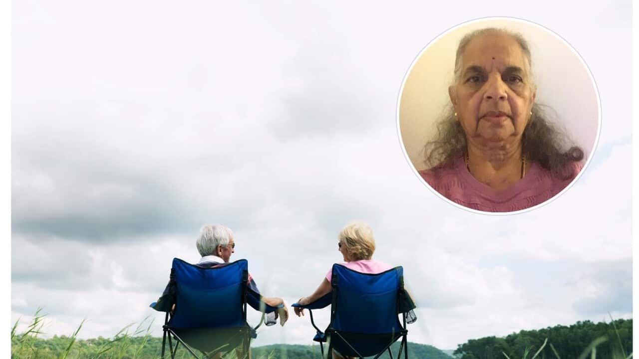 Elderly Man & Woman relaxing in deck chairs