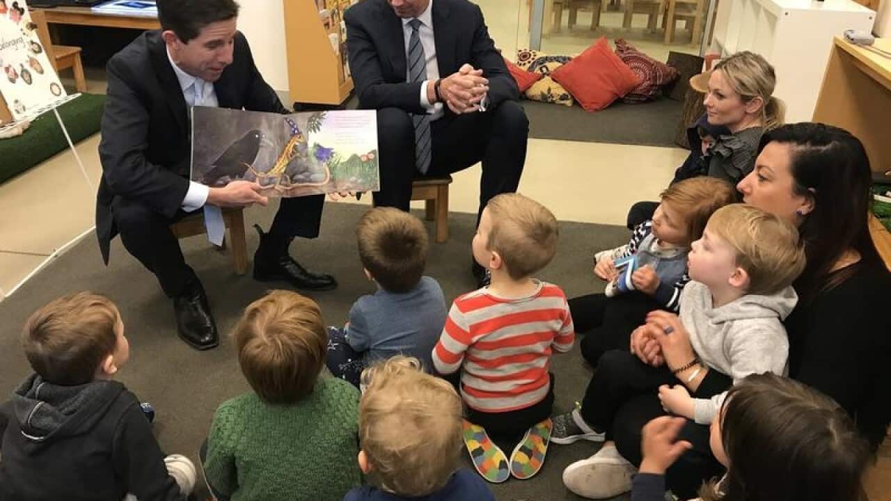 Minister for Education and Training Simon Birmingham (L)