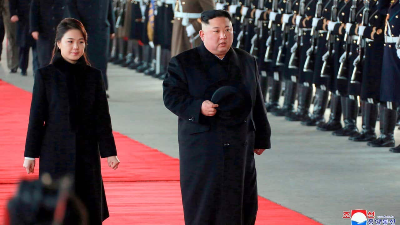 North Korean leader Kim Jong Un and his wife Ri Sol-ju reviewing a guard of honour as he leaves for China from Pyongyang, North Korea.