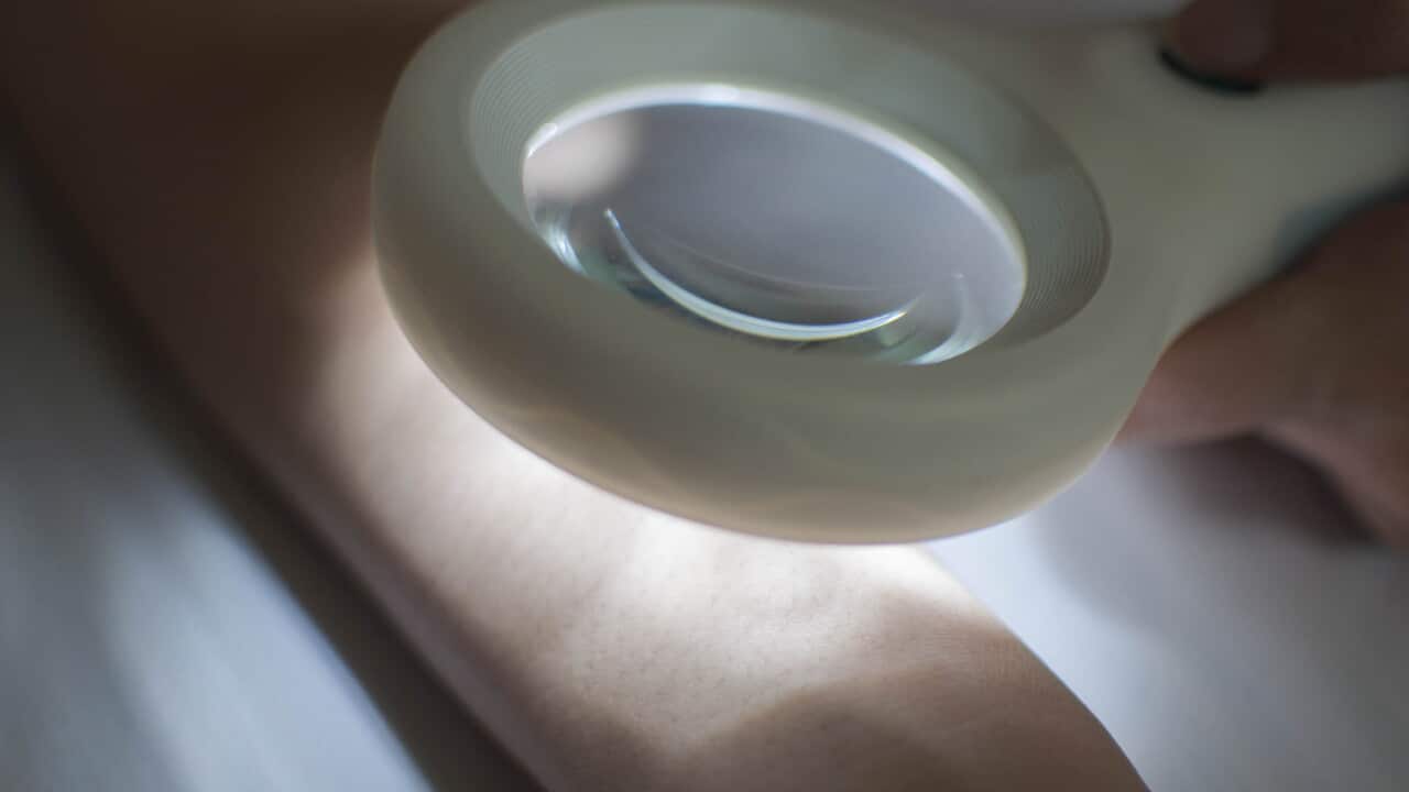 Using a magnifying lens for skin