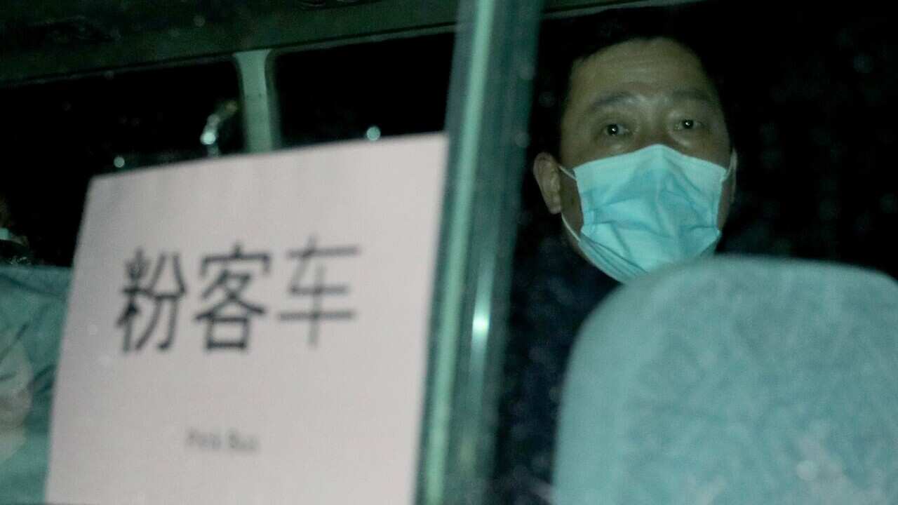 Australian evacuees leave by bus after arriving at the airport on Christmas Island.