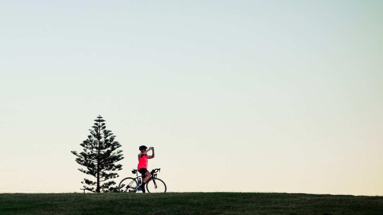 A rider stops to take a photograph of the sky